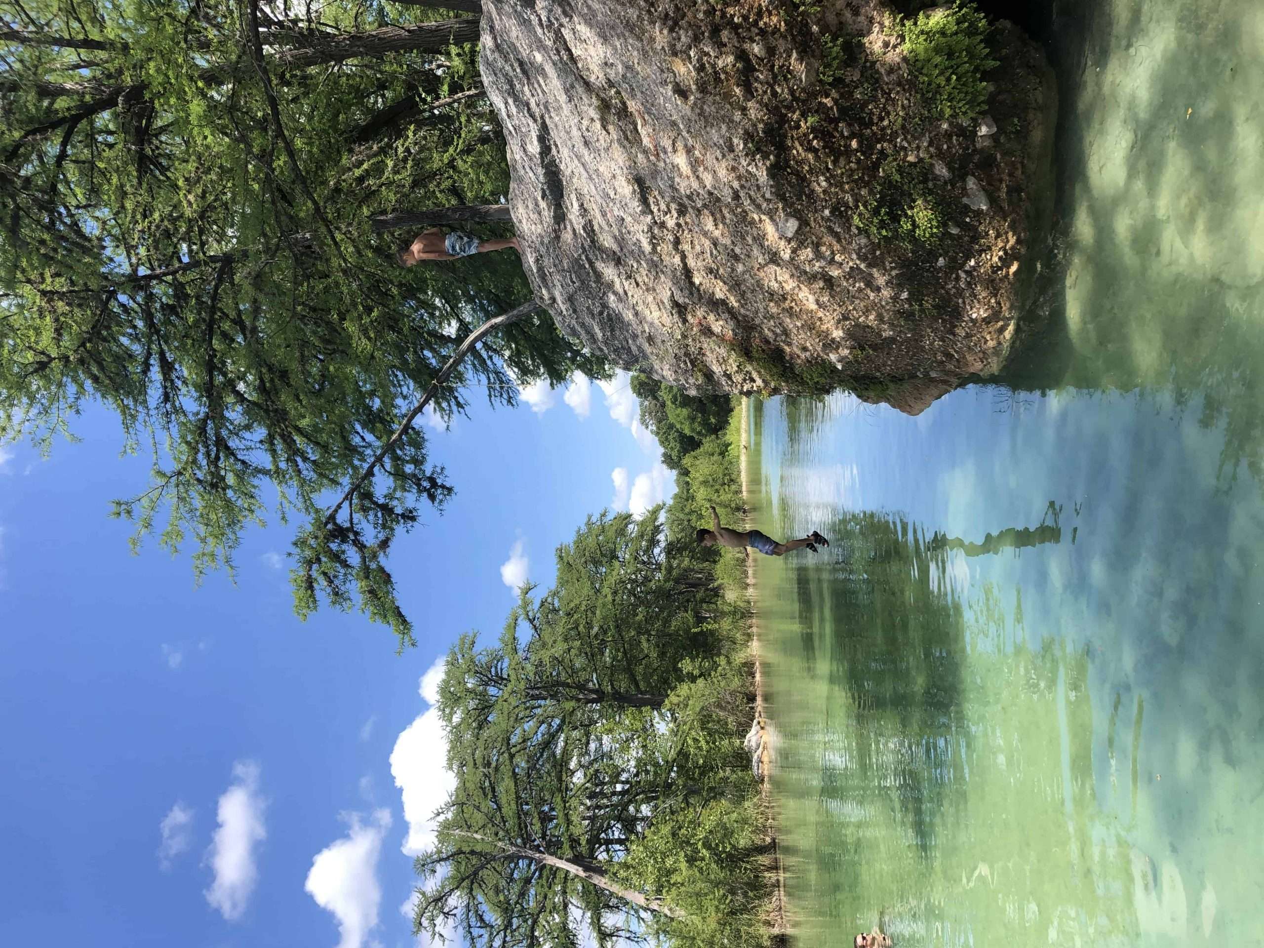 boy jumping in river