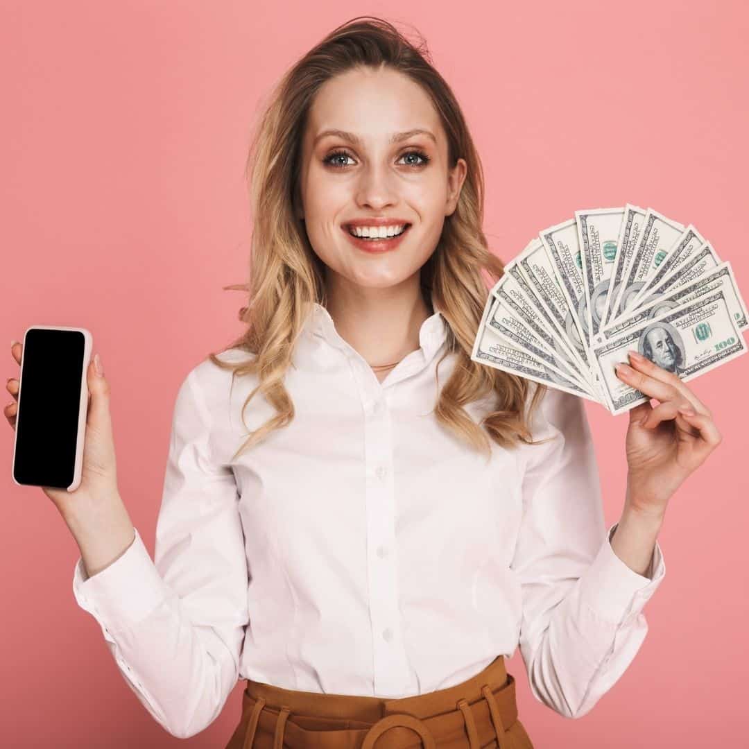 woman holding phone and money