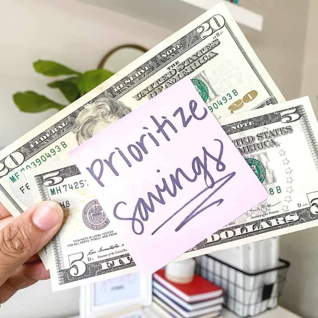 prioritize savings sticky note with cash