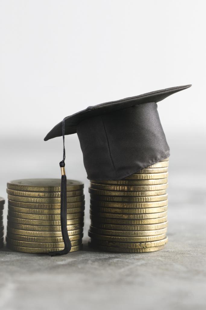 Graduation cap on top of coins