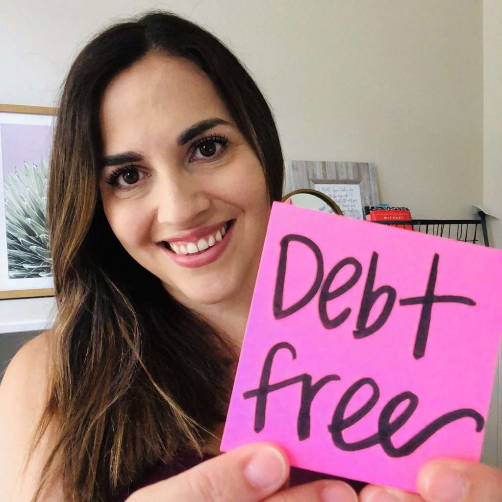 Woman holding up a debt free sign