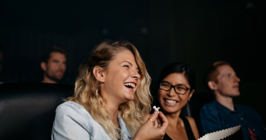 Two friends laughing at a comedy club